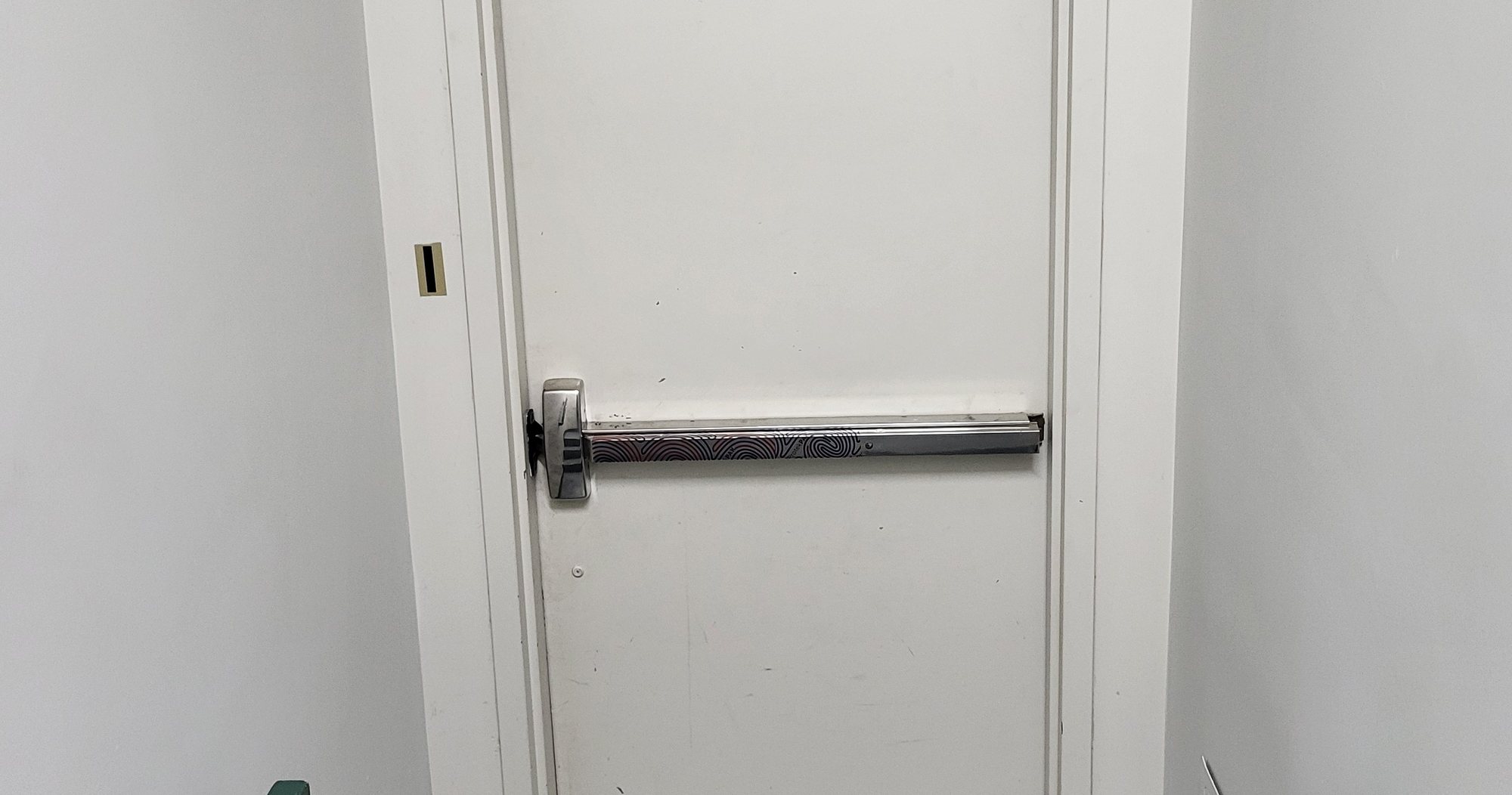 Commercial panic bar exit device on a steel door